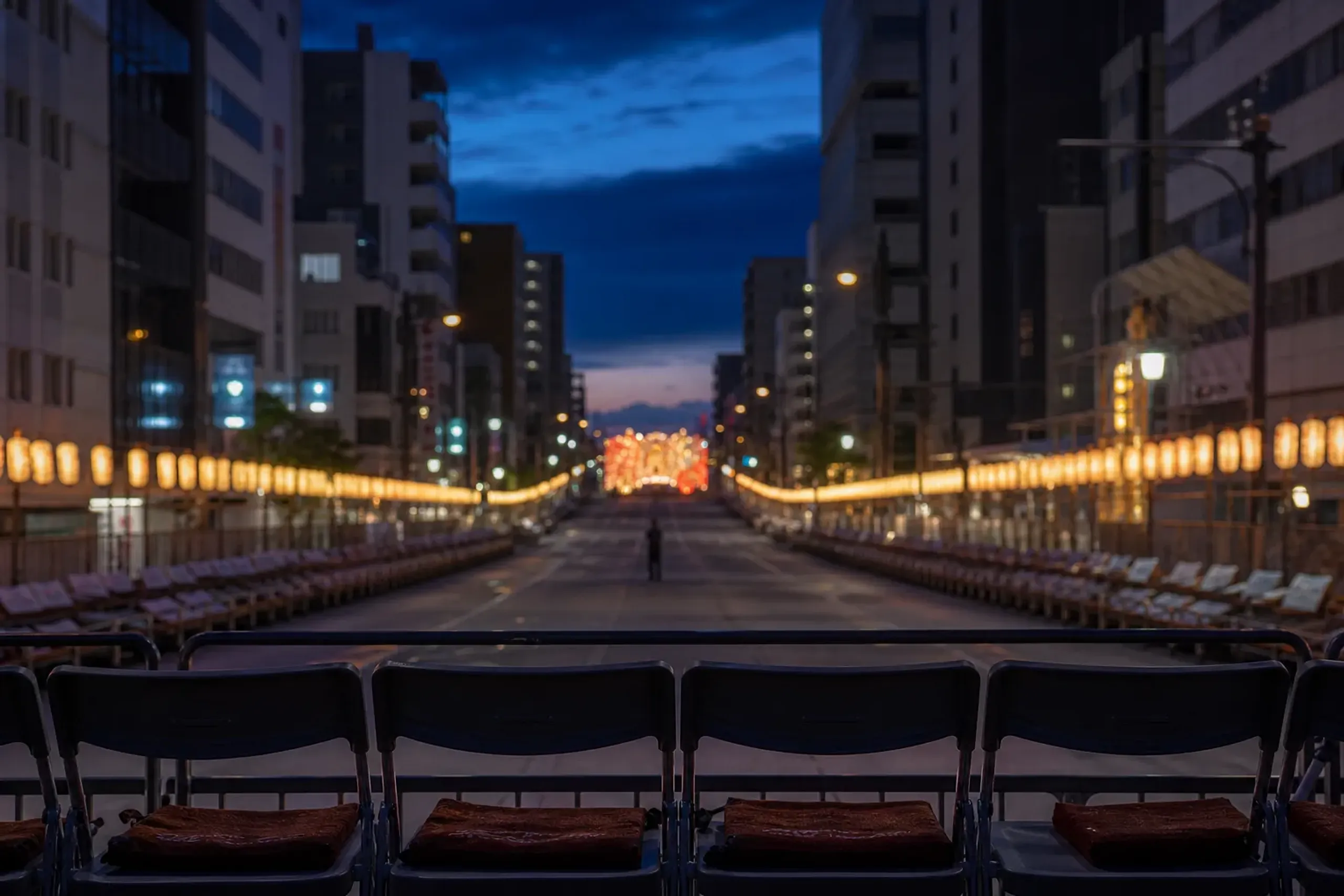 Reserved seating chairs set up along the Aomori Nebuta parade route with a clear sightline