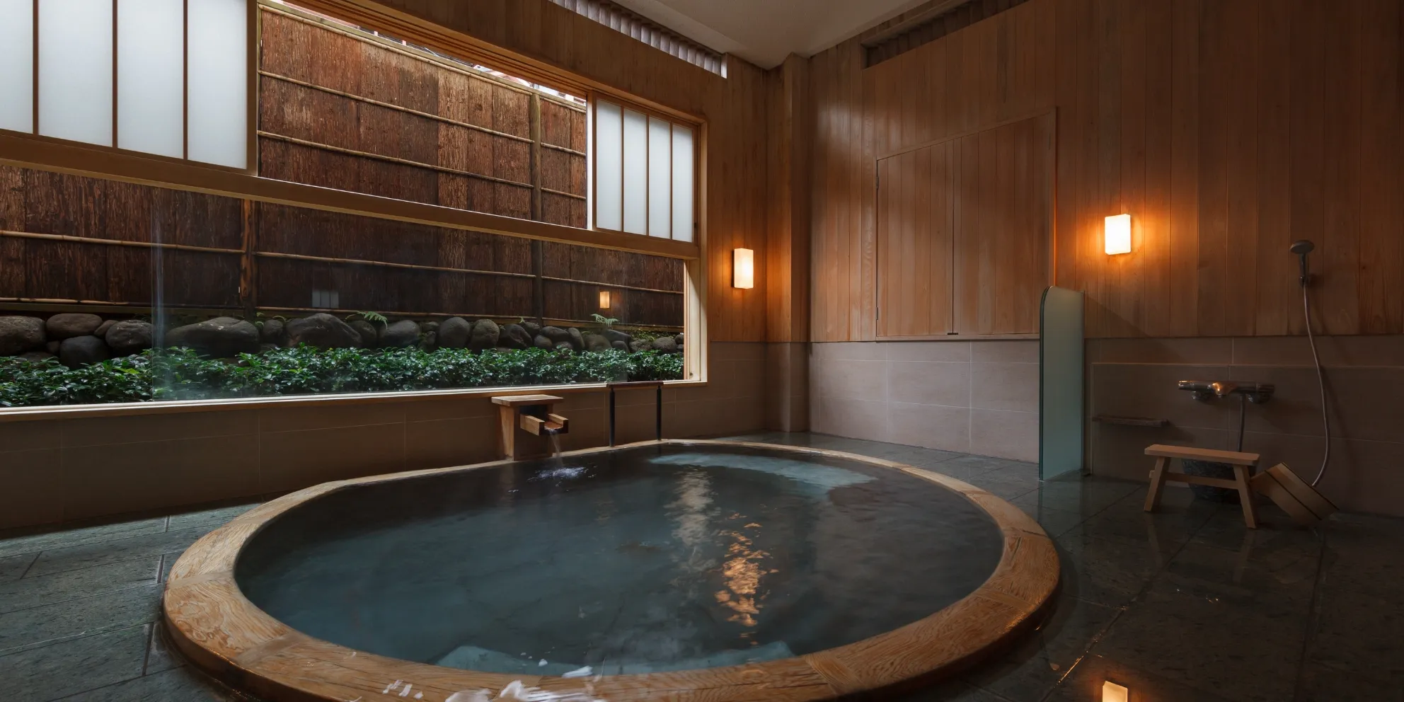 Cypress bath with continuously flowing hot-spring water at a ryokan in Shuzenji