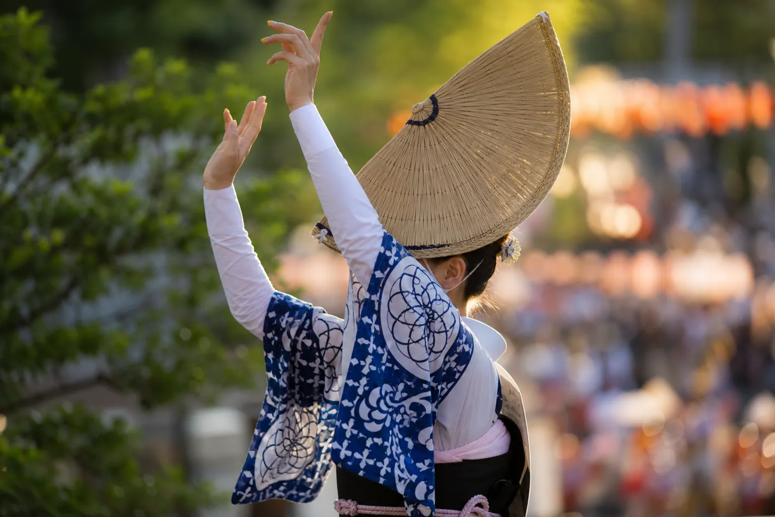 Female Awa Odori dancer in straw hat and yukata photographed from a clear reserved seat vantage