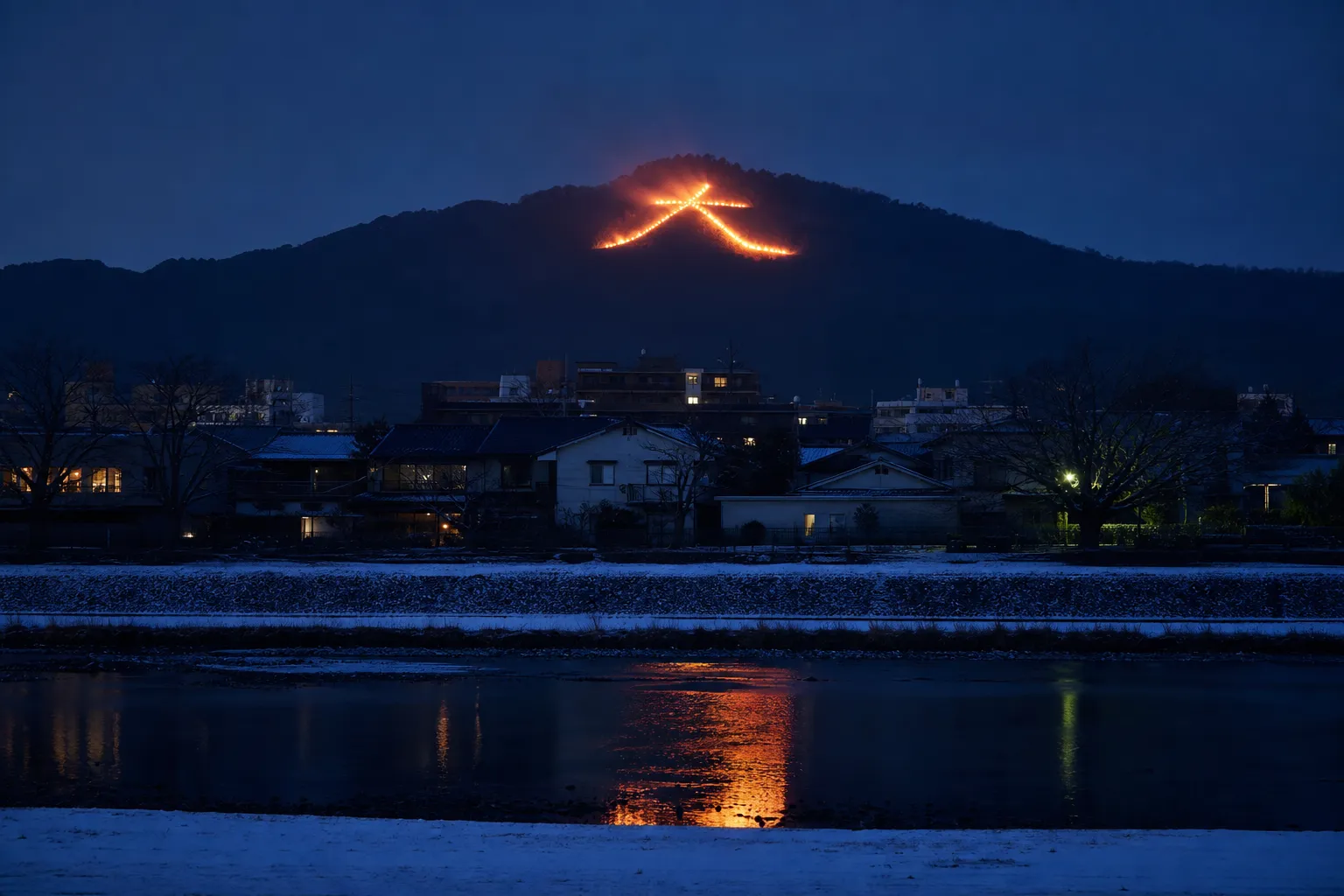 the giant flaming 'Dai' kanji character blazing on the slope of Mount Daimonji above Kyoto during the Gozan no Okuribi bonfire on the night of August 16