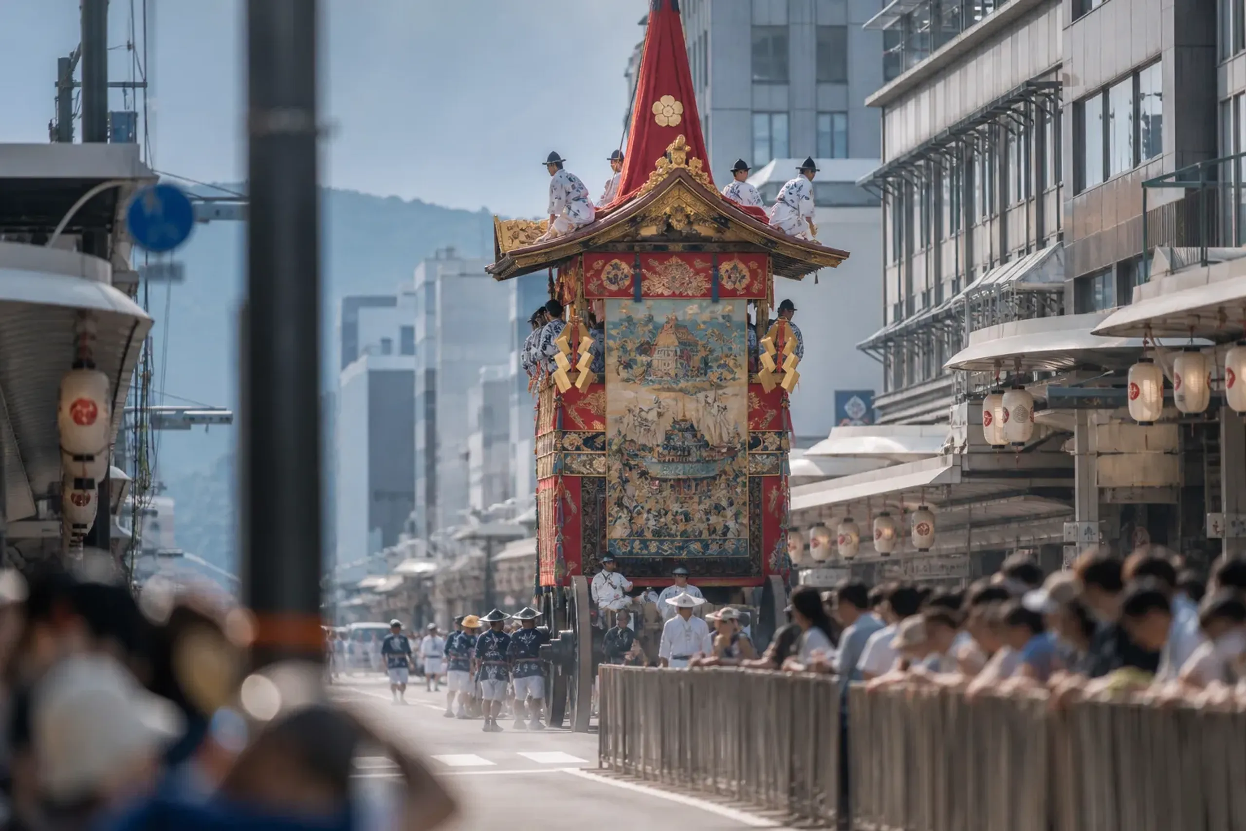 Gion Matsuri yamaboko float on a Kyoto street with crowd barriers during the procession