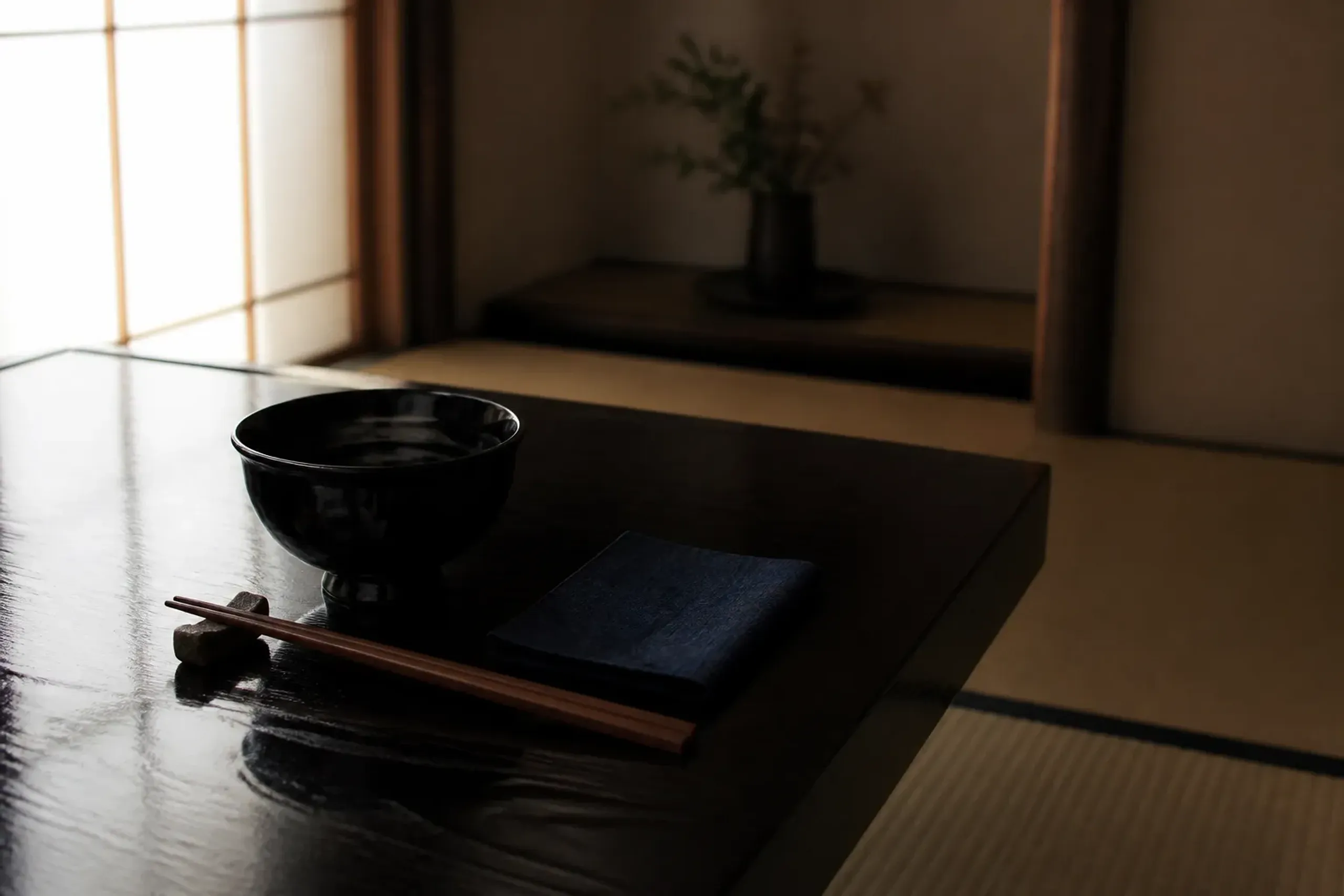 Minimal place setting in a private room suggesting a controlled guest list and privacy protocol