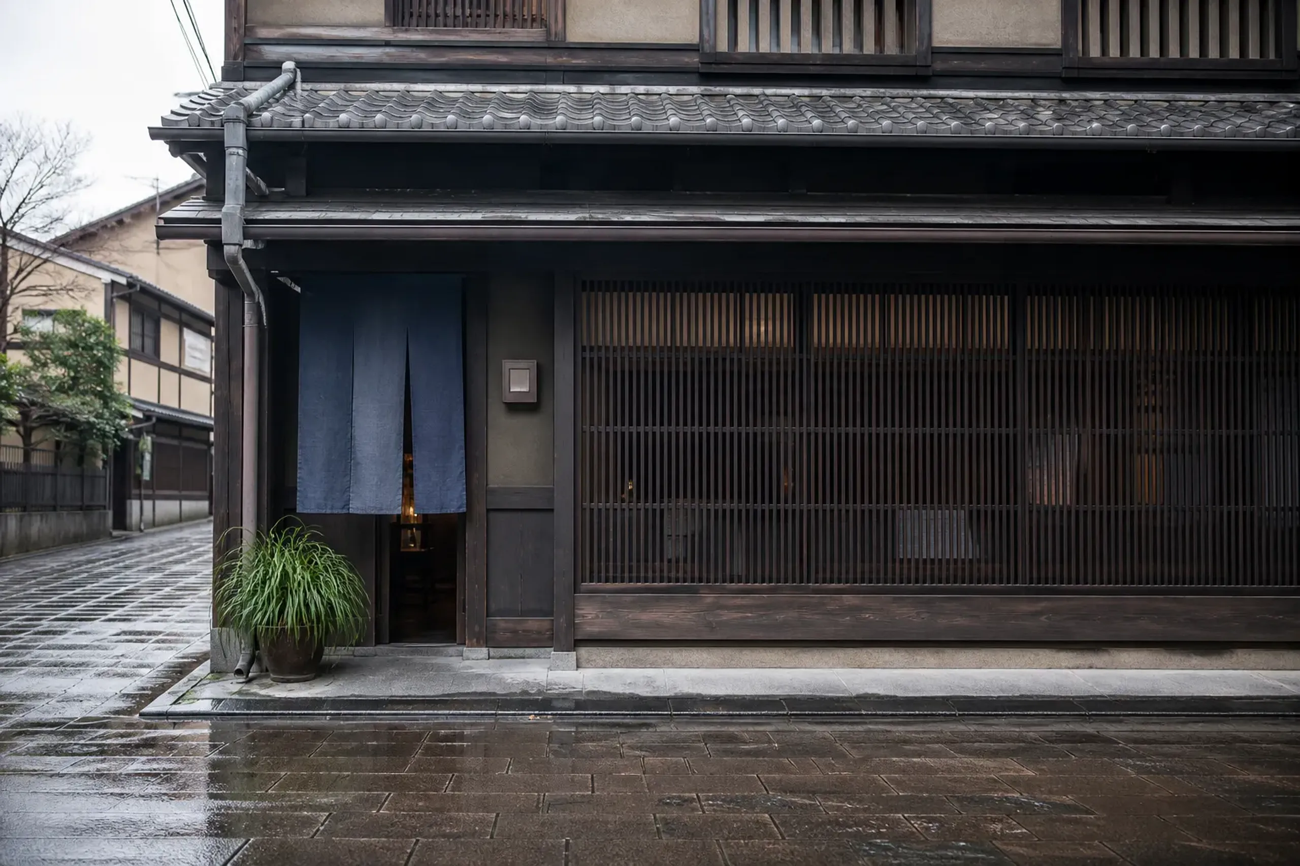 Renovated machiya townhouse in Kyoto with lattice facade and noren curtain