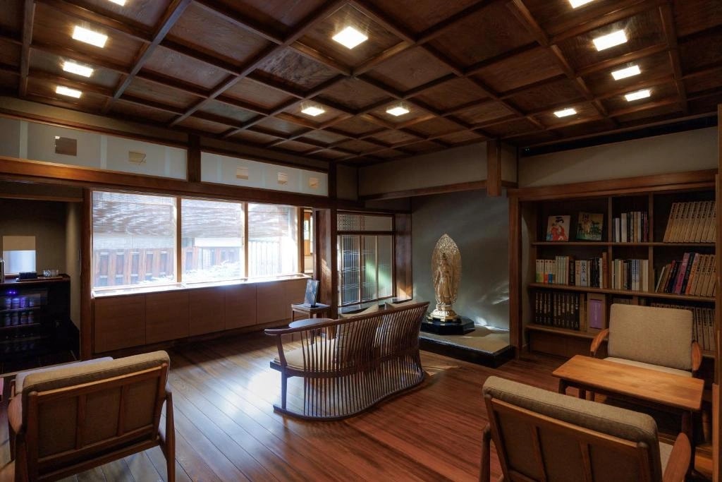 Japanese calligraphy displayed at a ryokan entrance in Kyoto under warm light