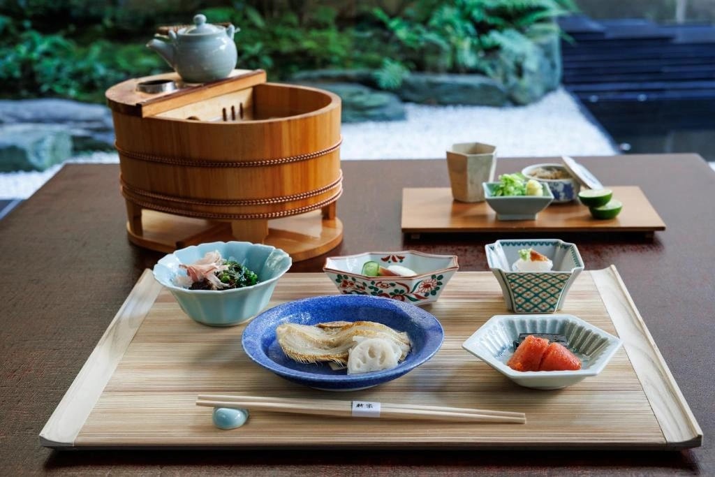 Seasonal kaiseki meal served in artisan Japanese vessels at a Kyoto ryokan