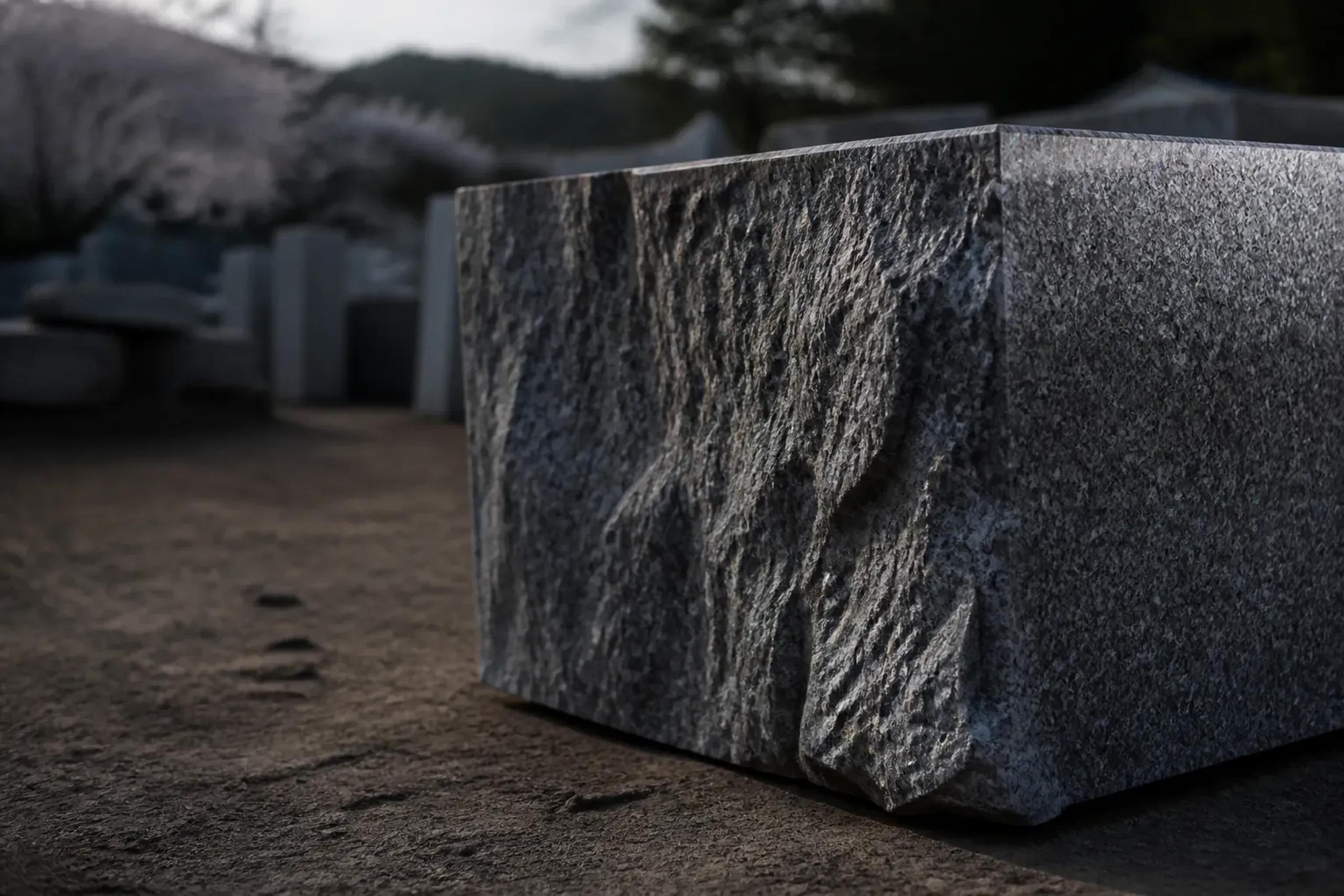 A freshly split block of Aji granite from the Mure hills, its fine-grained polished surface showing the faint mottling the local masons call fu