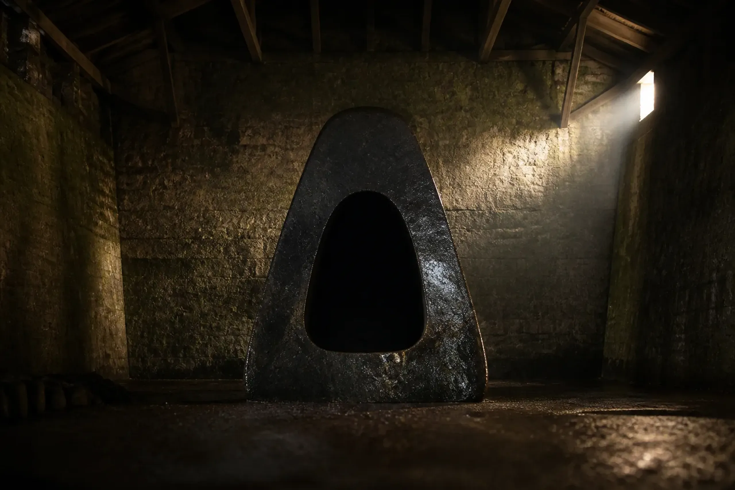 The sculpture Energy Void standing inside the exhibition storehouse at the Noguchi museum in Mure