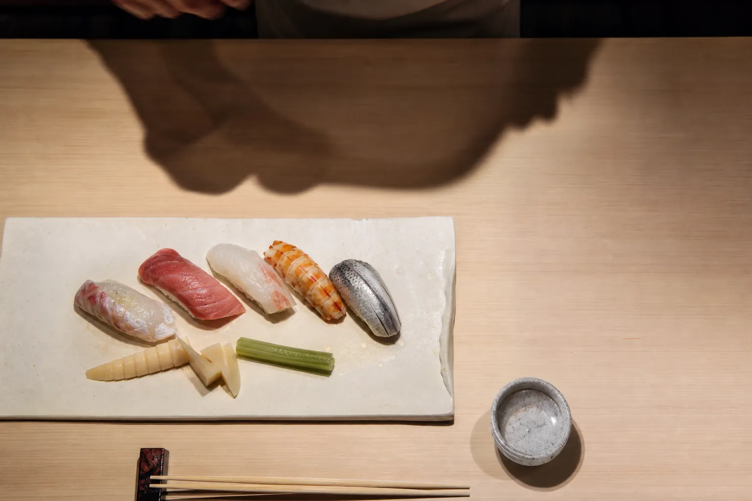 An exquisitely arranged platter of seasonal sushi and spring vegetables served in a high-end Osaka restaurant.