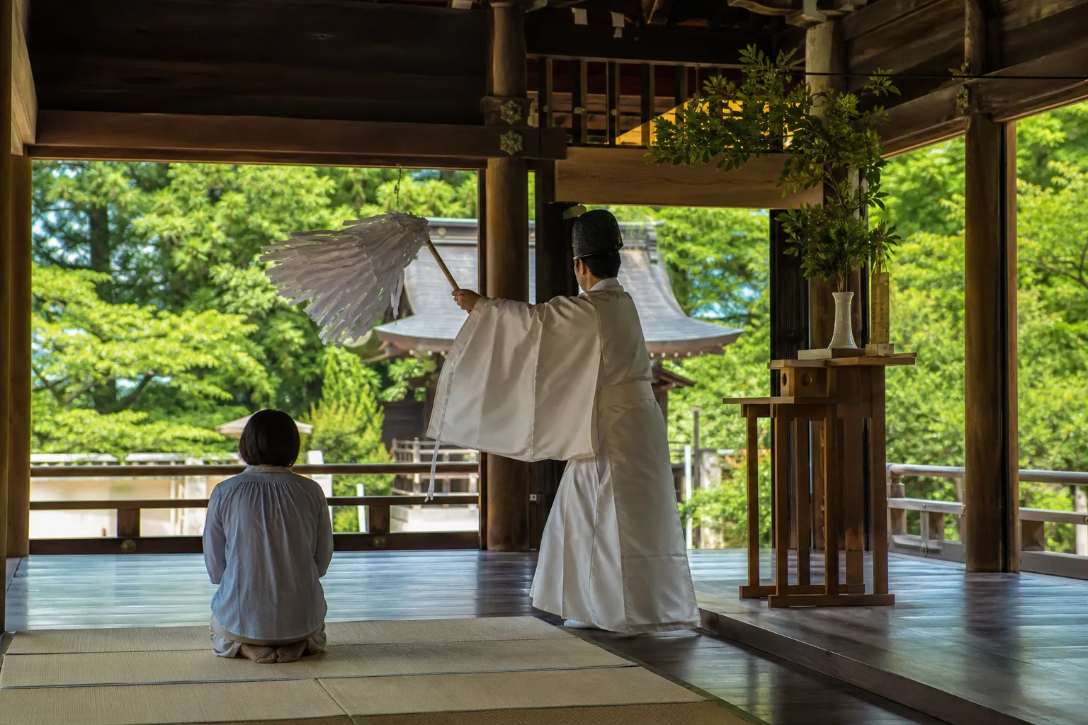 Shinto priest conducting a private New Year purification ritual in Japan.