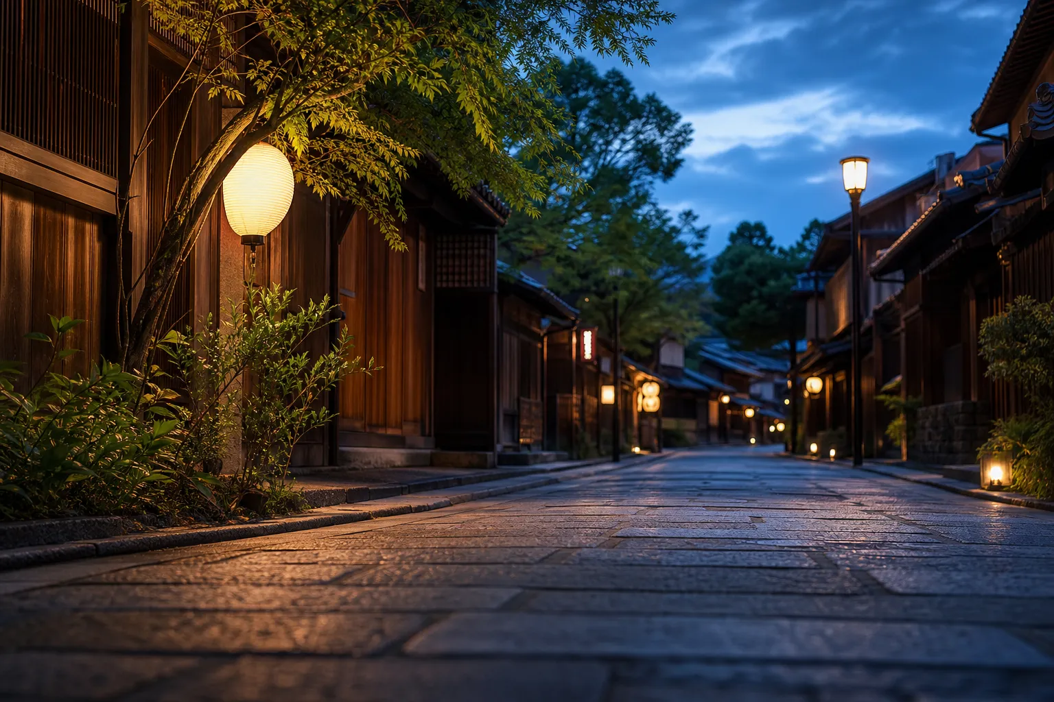 Quiet traditional Kyoto street with wooden machiya houses and lanterns at dusk