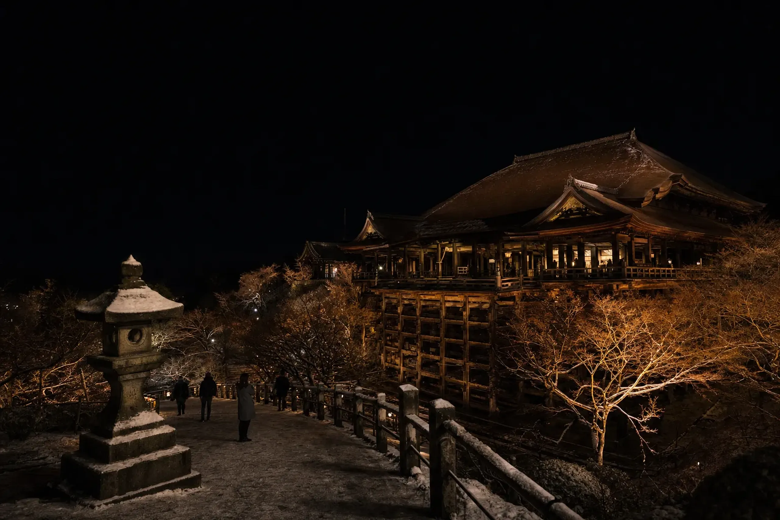 Kiyomizu-dera area at night with lantern light and a calm, lightly populated walkway