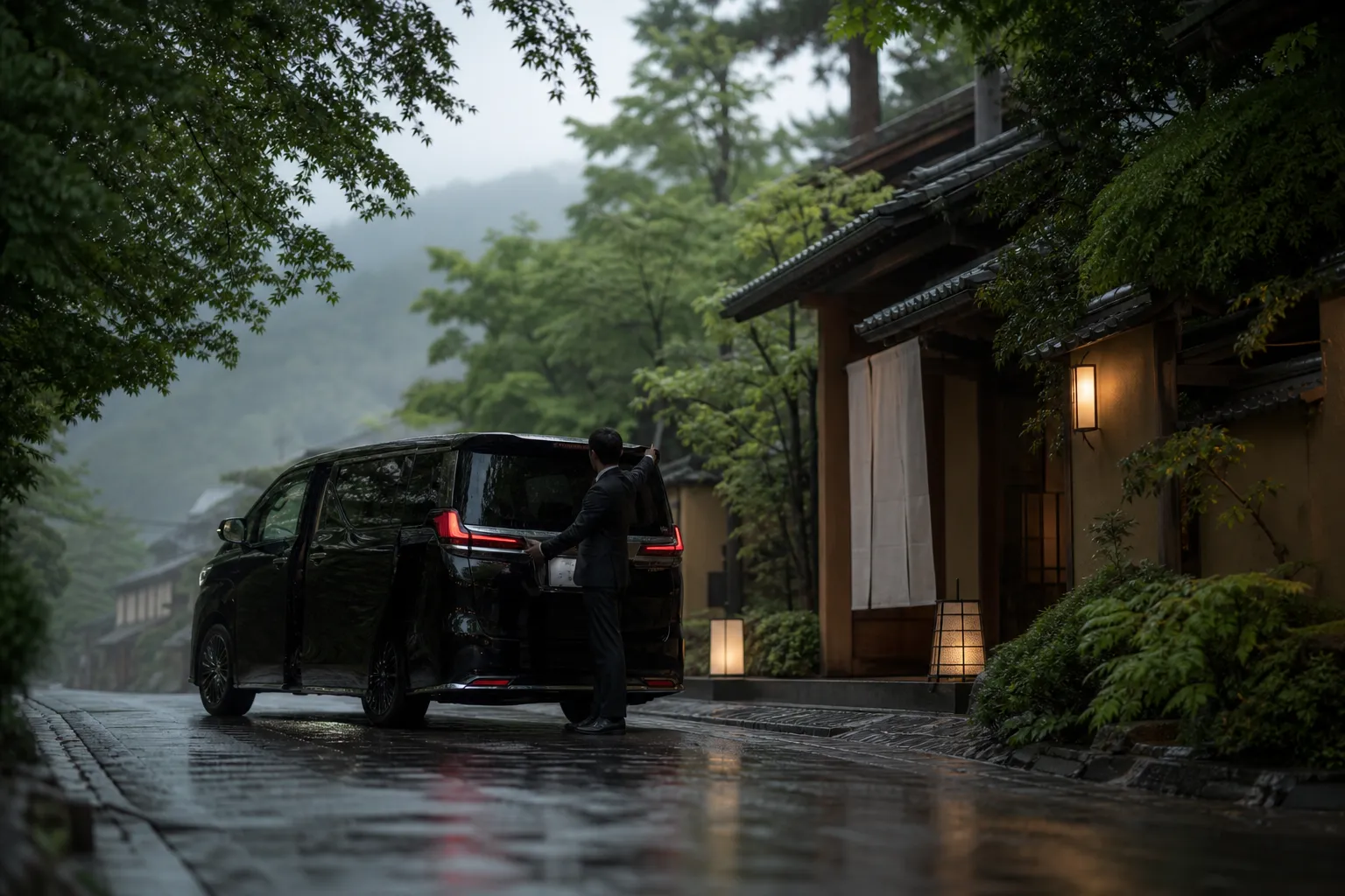 Luxury chauffeured minivan at a discreet Kyoto hotel entrance in the evening