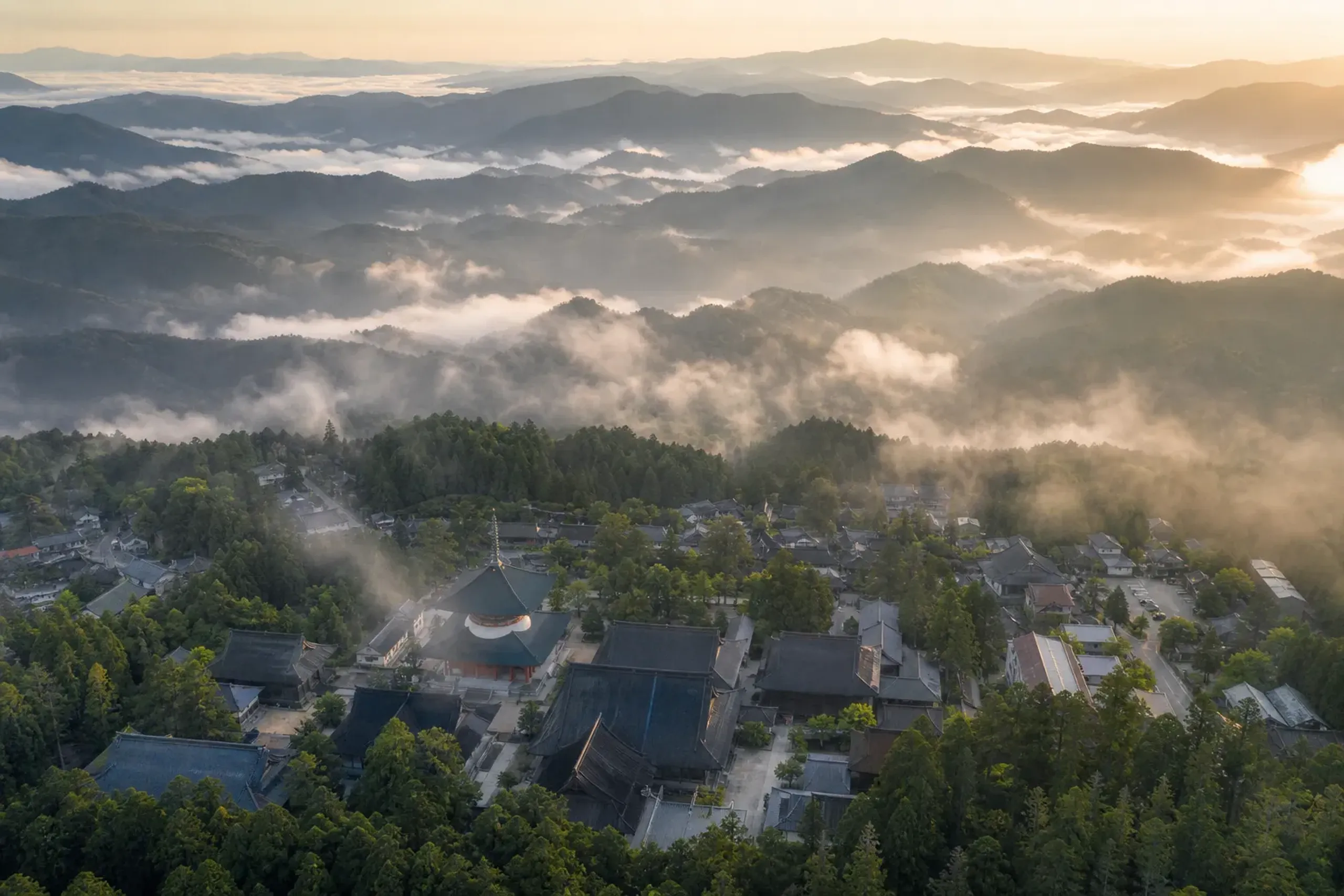 Aerial view of Koyasan temple town surrounded by cedar-covered mountains in morning mist