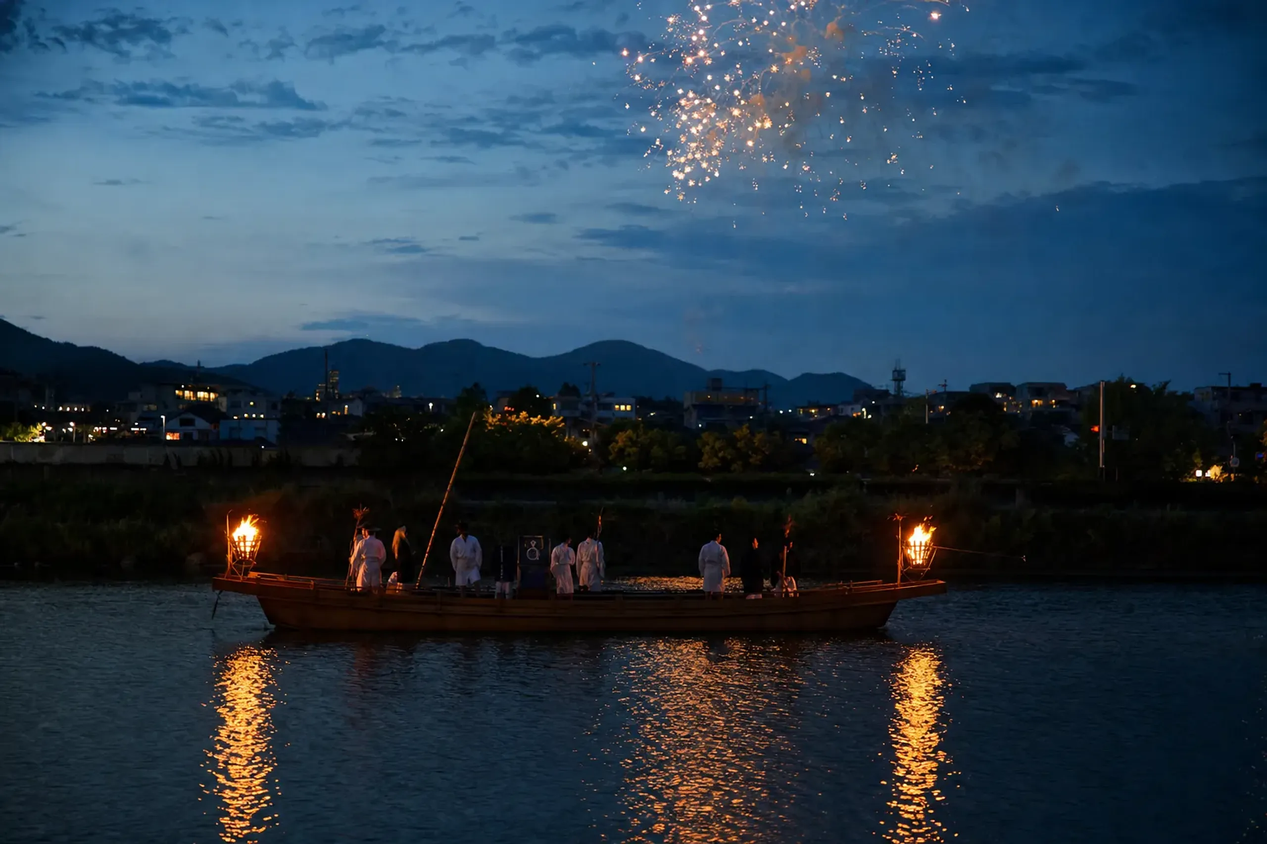 A procession vessel of the Funatogyo on the Ōkawa River at dusk, bonfires burning on its deck with fireworks reflected across the open water