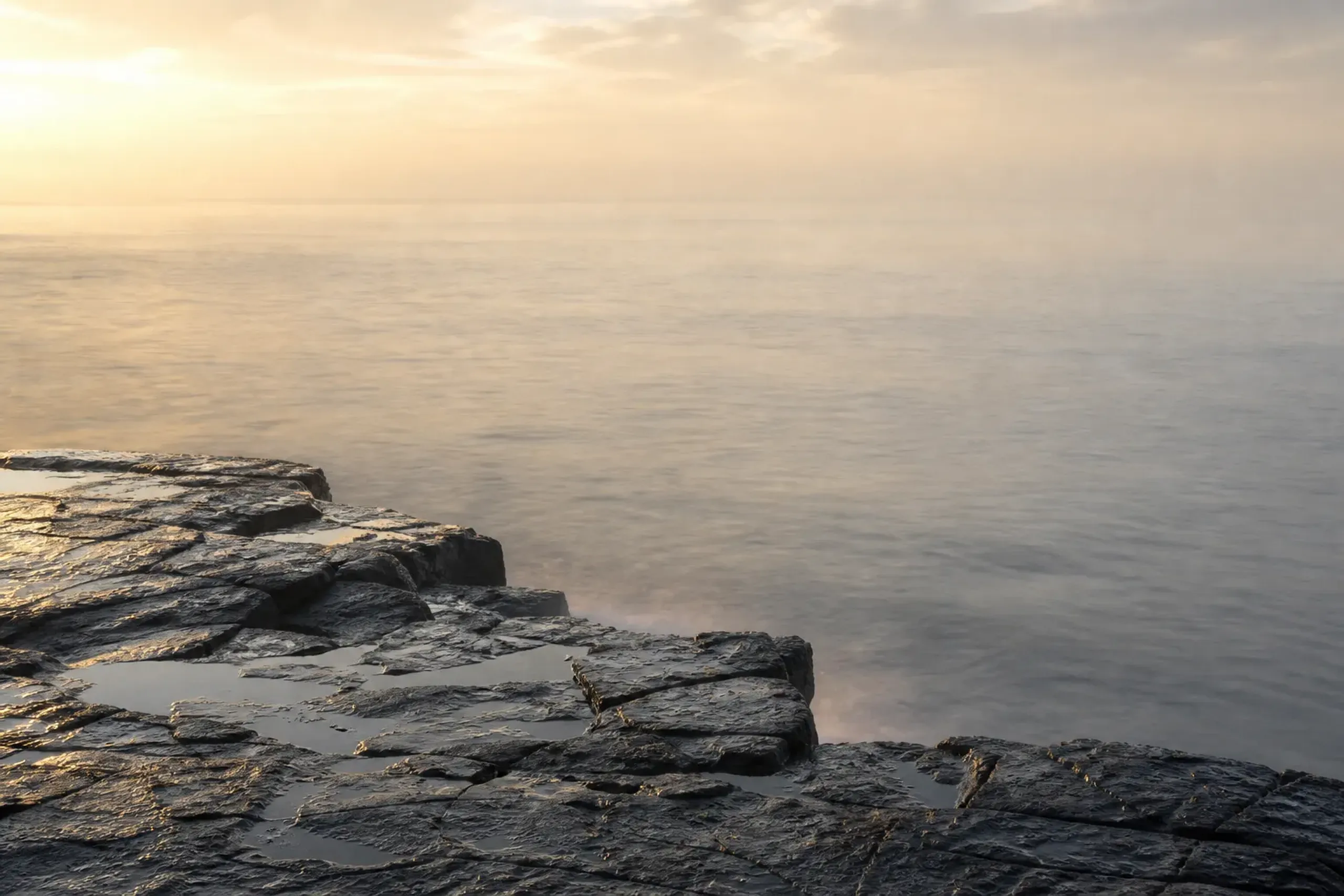 Remote volcanic coastline of the Oki Islands in the Sea of Japan with empty rock shelves and calm water