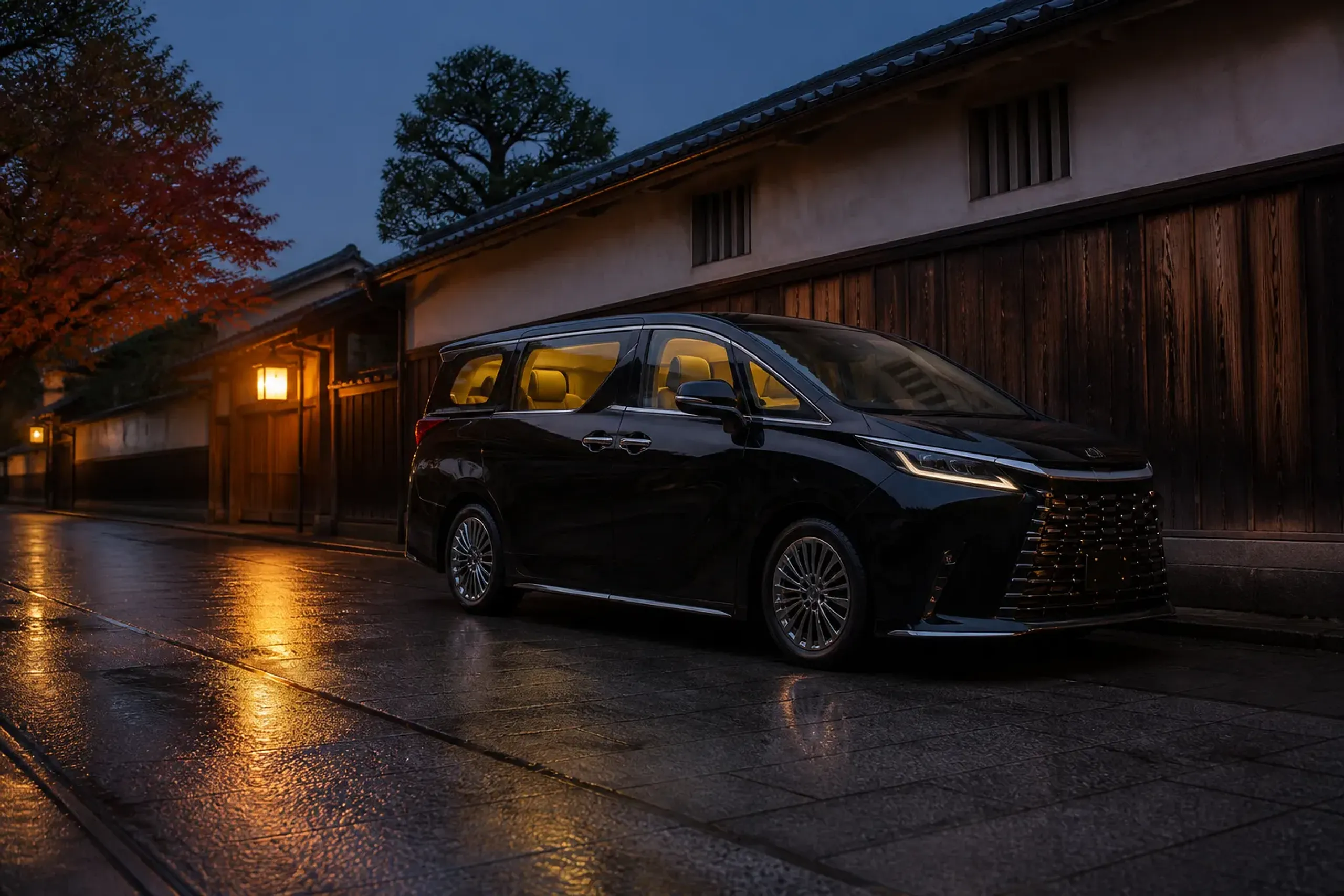 Black Lexus LM 500 private chauffeured minivan on a quiet Kyoto street at dusk