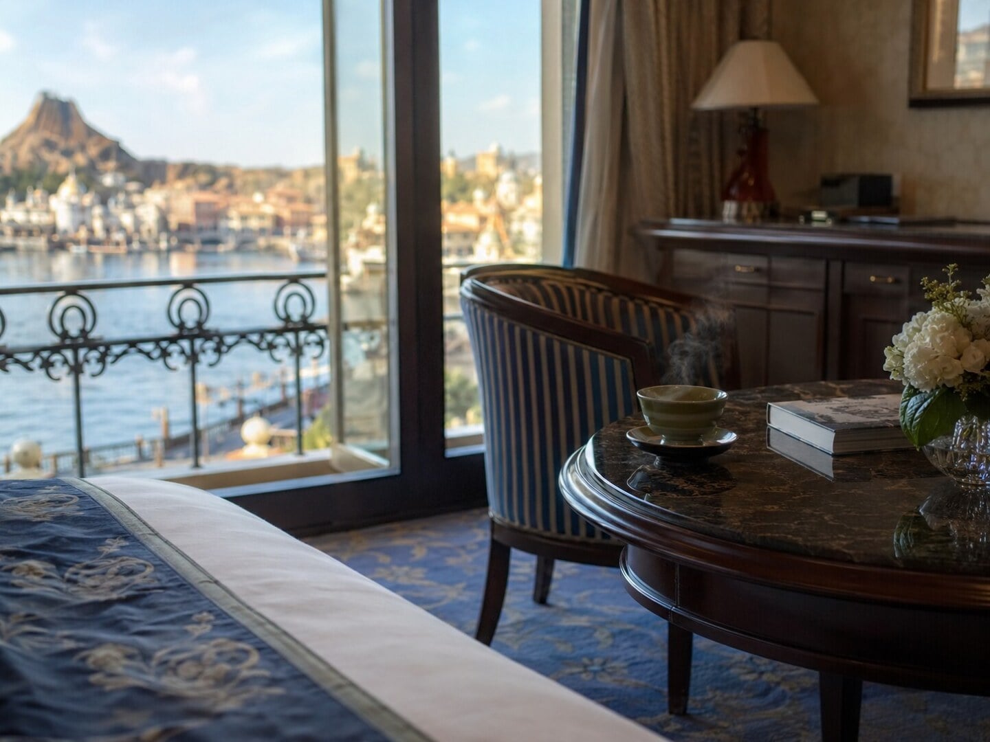 A luxurious hotel suite with a large window offering a panoramic view of a theme park harbor, highlighting the exclusivity of the VIP Tour.