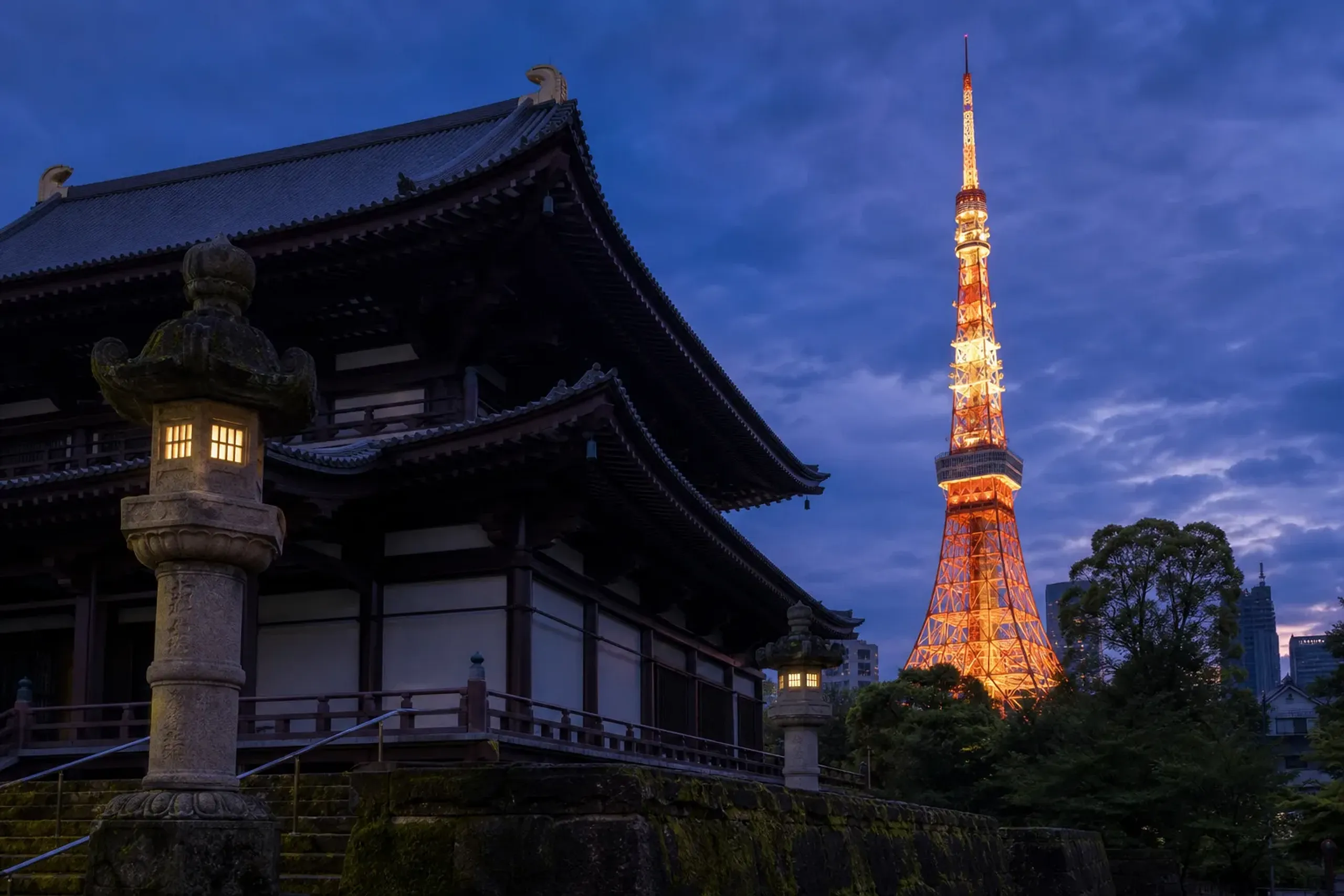 Traditional Zojoji Temple in the foreground with the illuminated Tokyo Tower in the background
