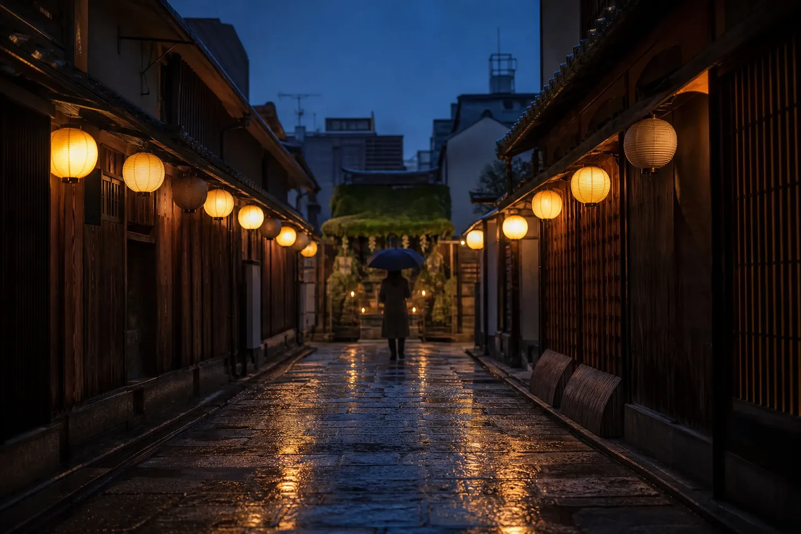 Lantern-lit Hozenji Yokocho alley in Osaka with wet stone pavement reflecting warm light