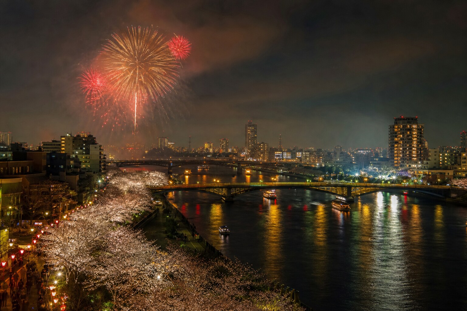 Fireworks over Tokyo’s Sumida River at night with reflections on the water