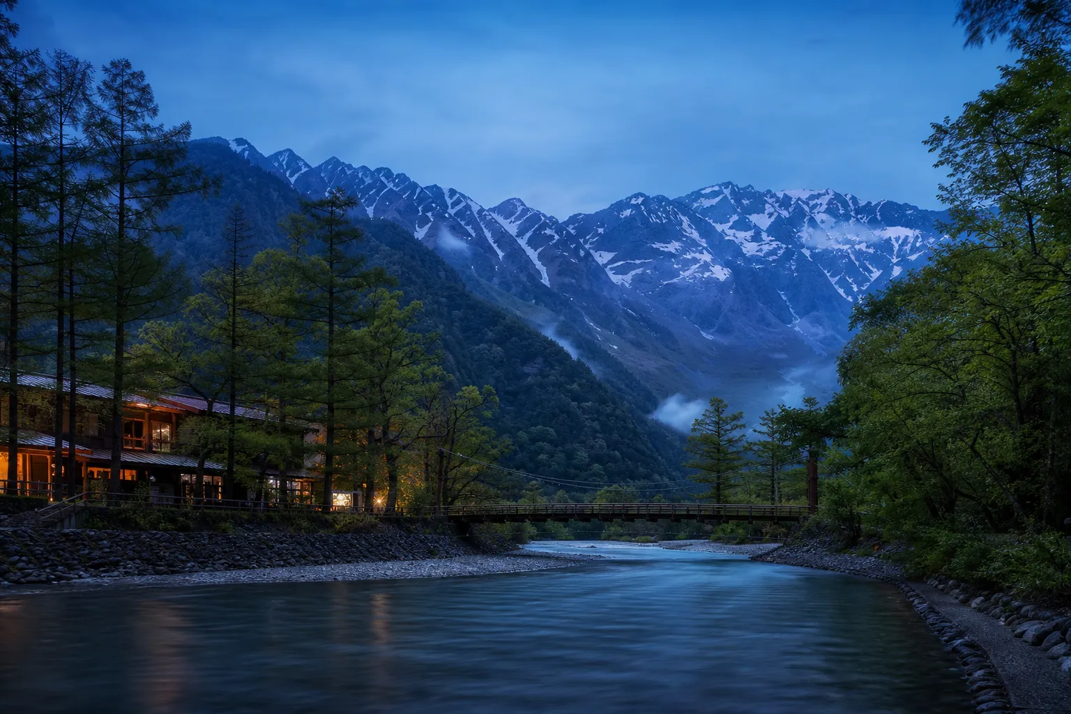 Turquoise Azusa River flowing through Kamikochi valley with the Hotaka mountain range behind
