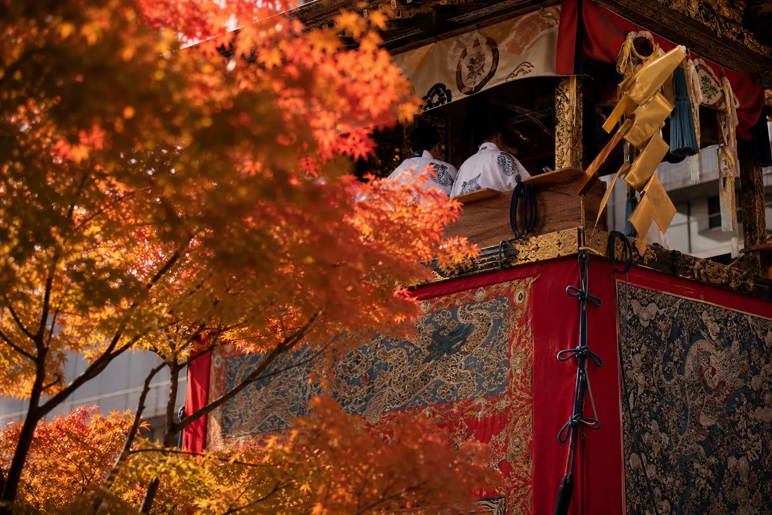 Tall traditional Gion Matsuri float pulled through a Kyoto street during the July procession