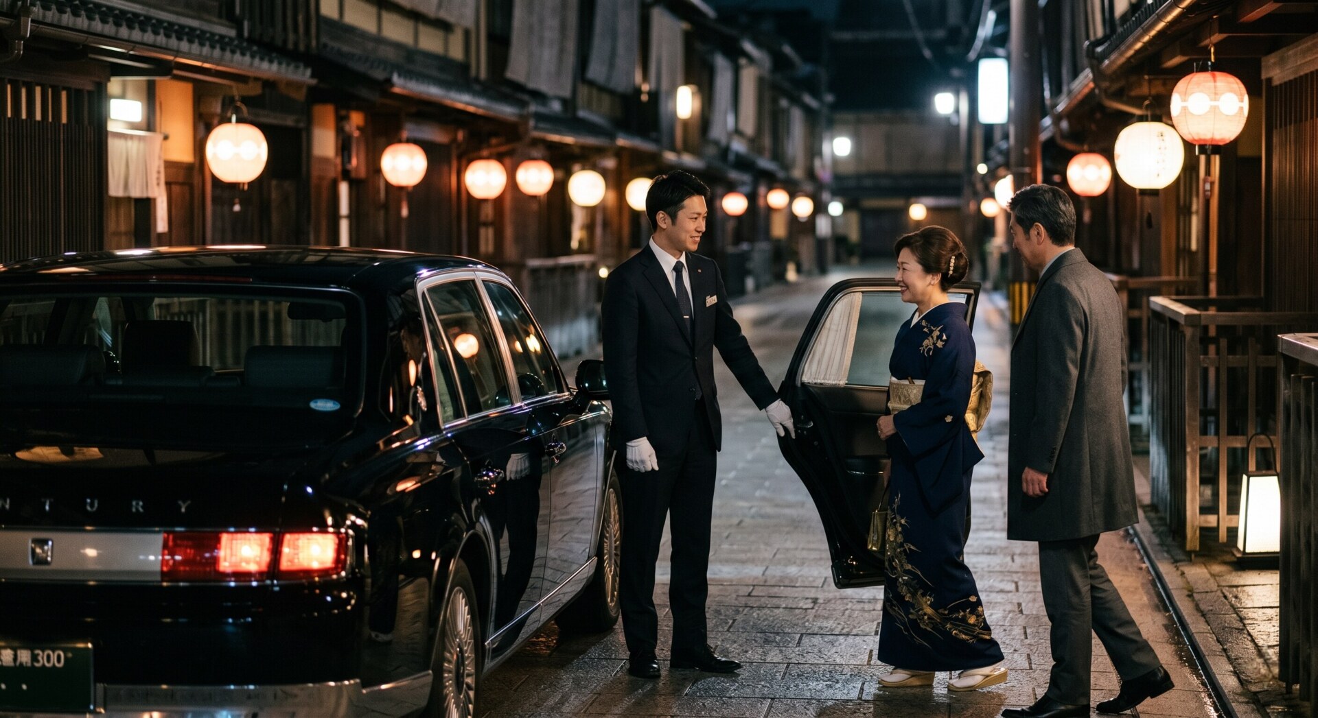 A private chauffeur from the Japanese Royal Service holding a car door open for a VIP guest in Osaka.
